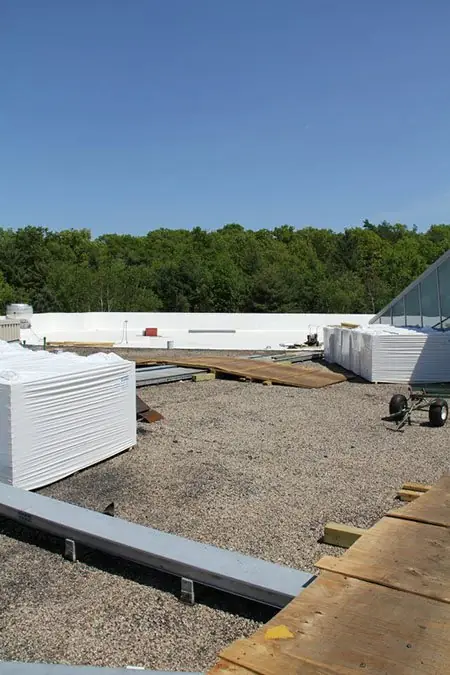 Metal coping and ballast along the edge of a flat commercial roof