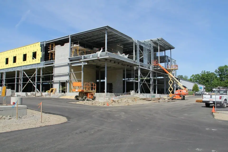 Steel frame of a new commercial building going up, with lifts on the slab